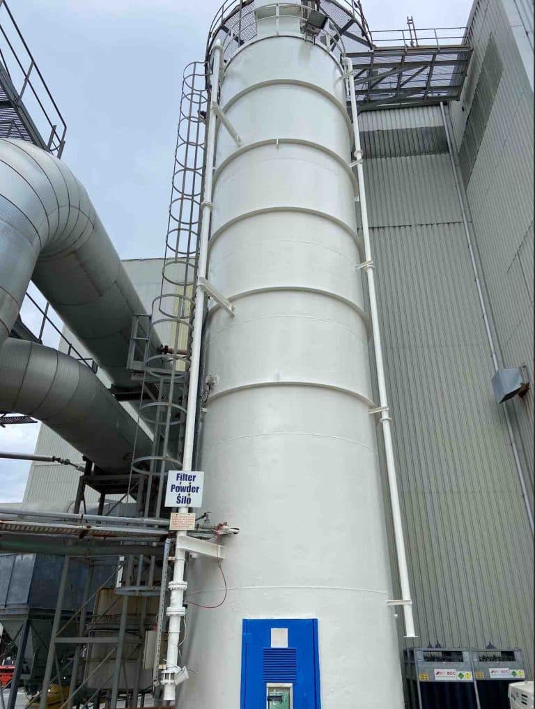 A finished cherry picker painting project of an industrial silo