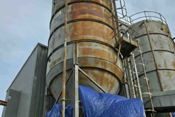 A rusted industrial silo. Protect steel from rust with industrial painting