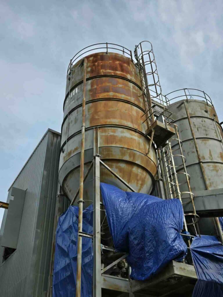 A rusted industrial silo. Protect steel from rust with industrial painting